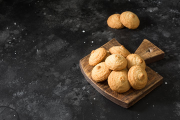Sesame cookies on a wooden Board on a black table