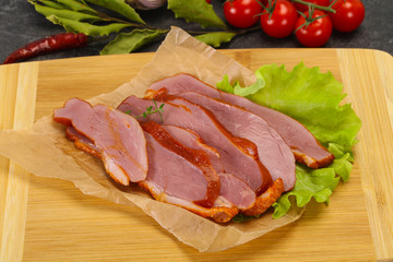 Sliced smoked duck breast served salad