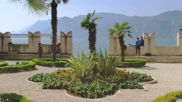 people visit medieval garden on Garda lake in Malcesine Verona Italy