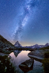 Milky way over lake Riffelsee with the reflection of the Matterhorn,  Zermatt, Switzerland