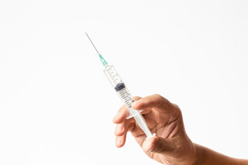 male hand holding a charged syringe and needle for treatment or vaccine campaign