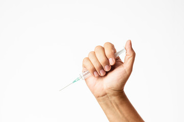 male hand holding a charged syringe and needle in a threatening attitude