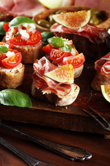 Tasty savory tomato Italian appetizers, or bruschetta on slices of toasted baguette garnished with basil