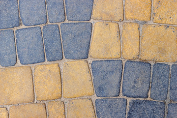 Yellow blue cobblestone pavement road. Background for text and copyspace.