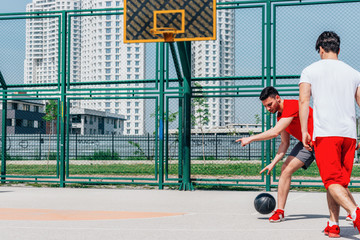 Basketball players playing ball in the middle of the day