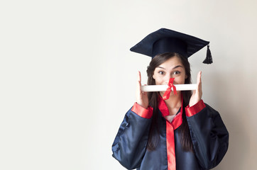 Happy young woman with diploma on graduation day