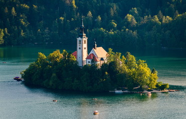 View of the island on Lake Bled with Pilgrimage Church of the Assumption of Maria during sunset...
