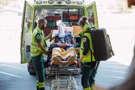 Paramedics taking out patient from ambulance