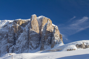 Sella Towers in Winter covered in Deep Snow. Passo Sella during a Sunny Winter Day just above Selva Val Gardena