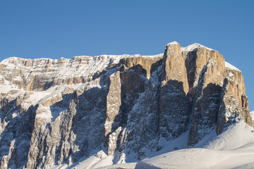 Fototapeta na wymiar Sella with the Sella Towers covered in Snow. Winter Landscape in the Dolomites. Winter scenery just above Val Gardena