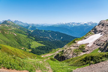 Naklejka premium View over the Green Valley, surrounded by high mountains on a clear summer day