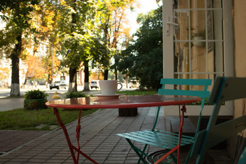 Fototapeta na wymiar Street cafe - a round table with a cup of coffee
