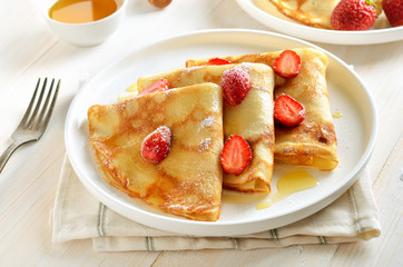 Crepes with strawberry slices