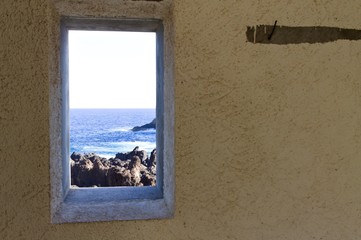 Ocean view through an isolated narrow window (Porto Moniz, Madeira, Portugal)