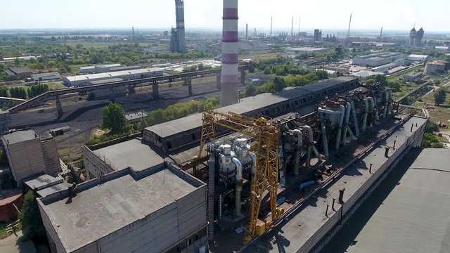 urban coal boiler house aerial view. the drone flies over the heat station of the city with heat and hot water. Boilers use coal. Pipes are smoked and coal dust collectors are installed.