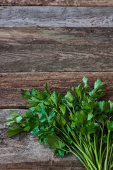 Bunch of fresh green parsley on an old rough wooden surface, healthy eating concept, selective focus