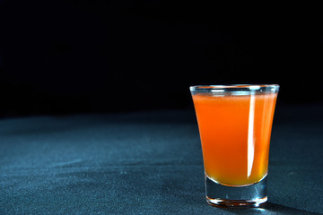 ALCOHOLIC DRINK WITH FRUIT COCKTEL on black background