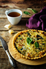 bacon spinach quiche with fresh spinach leaves