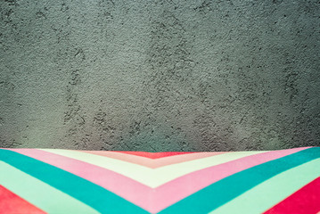 bright multi-colored corner ornament textured on a gray concrete background