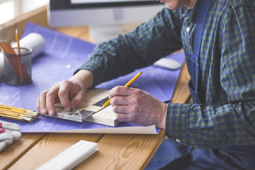 Engineer carpenter working on laptop and sketching project