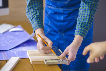Engineer carpenter working on laptop and sketching project