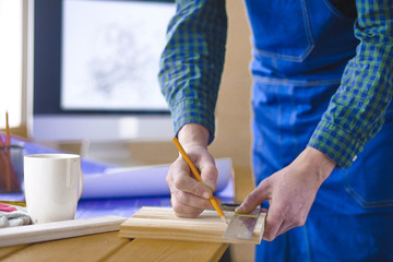 Engineer carpenter working on laptop and sketching project