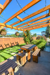 Barbecue and picnic area of hotel with row of tables and grills under the shed.
