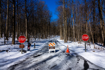 Parking direction sign on icy path
