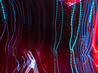 Background with chaotic colored lines. Abstract image of the play of light. Curved light lines