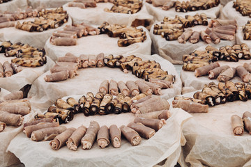 Close-up of many servings of meat and vegetarian rolls made of pork and aubergine served on platters over baking paper. Special event organization. Catering concept.