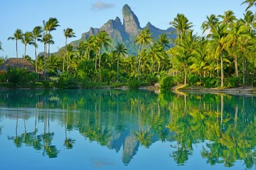 View of the Mont Otemanu mountain reflecting in water at sunset in Bora Bora, French Polynesia,...