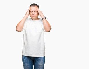 Fototapeta premium Middle age arab man wearig white t-shirt over isolated background with hand on head for pain in head because stress. Suffering migraine.