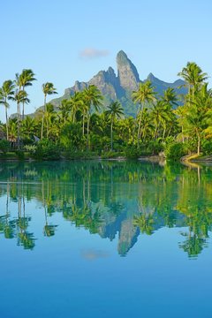 View of the Mont Otemanu mountain reflecting in water at sunset in Bora Bora, French Polynesia, South Pacific
