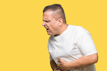 Middle age arab man wearig white t-shirt over isolated background with hand on stomach because nausea, painful disease feeling unwell. Ache concept.