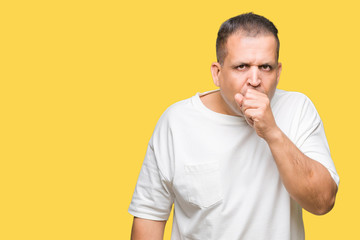 Middle age arab man wearig white t-shirt over isolated background feeling unwell and coughing as symptom for cold or bronchitis. Healthcare concept.