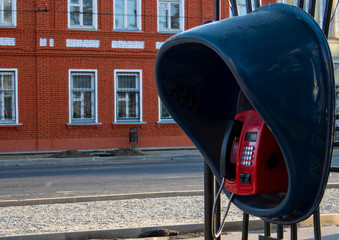 Old and shabby outdated urban payphone.public dirty