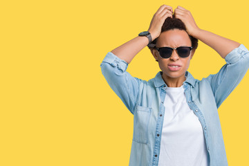 Beautiful young african american woman wearing sunglasses over isolated background suffering from headache desperate and stressed because pain and migraine. Hands on head.