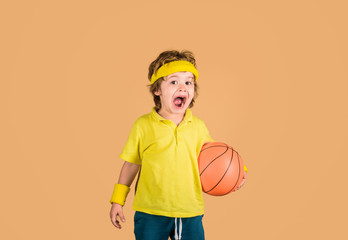 Hobby sport concept. Kid holds basketball. Kid playing with basketball. Sporty boy with ball. Sport...