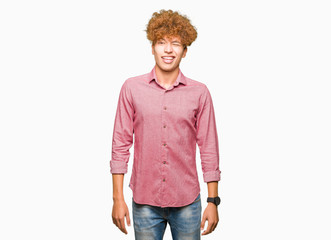 Young handsome business man with afro hair winking looking at the camera with sexy expression,...