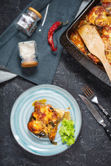 Baked eggplant with cheese on a stone table. Parmigiana melanzane. Italian cuisine.