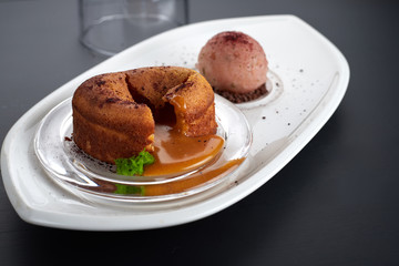 Caramel fondant on a white dish with an ice-cream