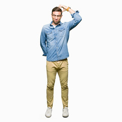 Fototapeta premium Handsome man wearing glasses confuse and wonder about question. Uncertain with doubt, thinking with hand on head. Pensive concept.