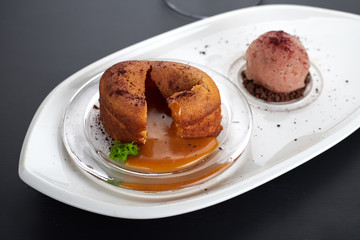 Caramel fondant on a white dish with an ice-cream