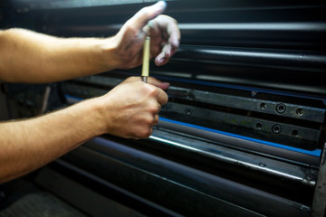 The master have service an industrial offset printing press machine. The process of tuning the...