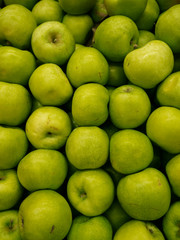 Green Apple Background, shallow depth of field.  Fresh green apples lying heaped