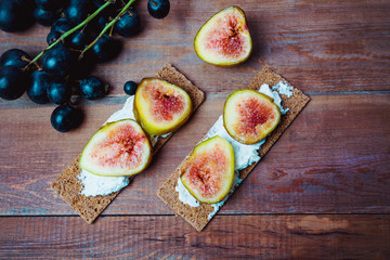 Homemade wheaten bread sliced and topped with cream cheese and fresh figs