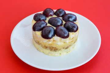 The legendary Tiffany layered salad with grapes, chicken and cheese on the red background.