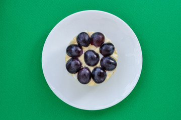 The legendary Tiffany layered salad with grapes, chicken and cheese on the green background.