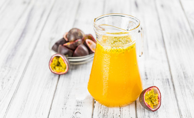 Portion of fresh Maracuja Juice (selective focus; close-up shot).