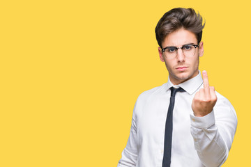 Young business man wearing glasses over isolated background Showing middle finger, impolite and...